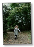 Picture of a female child walking alone listening to nature with no-one to communicate with 