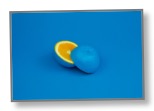 Picture of an Orange with blue skin on blue background to communicate an alternate perspective