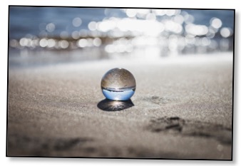 Picture of an orb on the beach to communicate an alternate perspective 